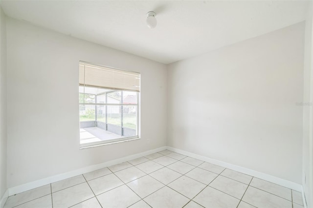 657 Mckinley Ct, Kissimmee, FL 34758 - empty room with baseboards and light tile patterned floors