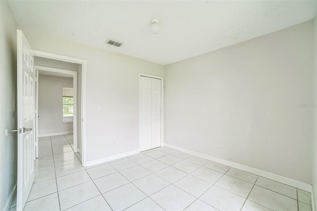657 Mckinley Ct, Kissimmee, FL 34758 - empty room with light tile patterned floors and baseboards