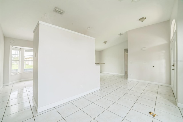 657 Mckinley Ct, Kissimmee, FL 34758 - empty room with vaulted ceiling, light tile patterned floors, and baseboards