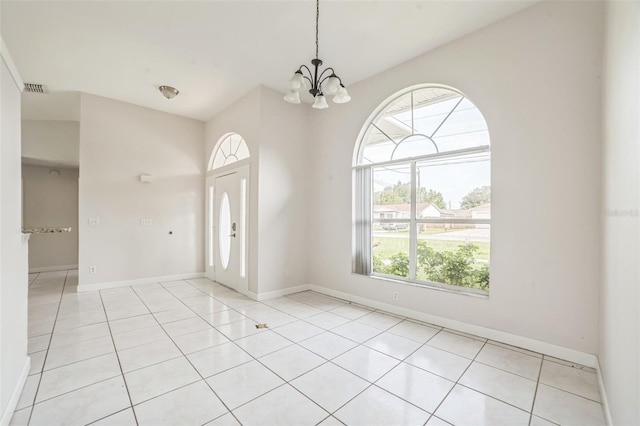 657 Mckinley Ct, Kissimmee, FL 34758 - entryway featuring a chandelier, baseboards, and light tile patterned floors