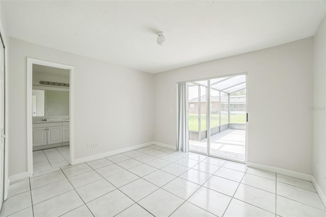 657 Mckinley Ct, Kissimmee, FL 34758 - empty room with light tile patterned flooring and baseboards