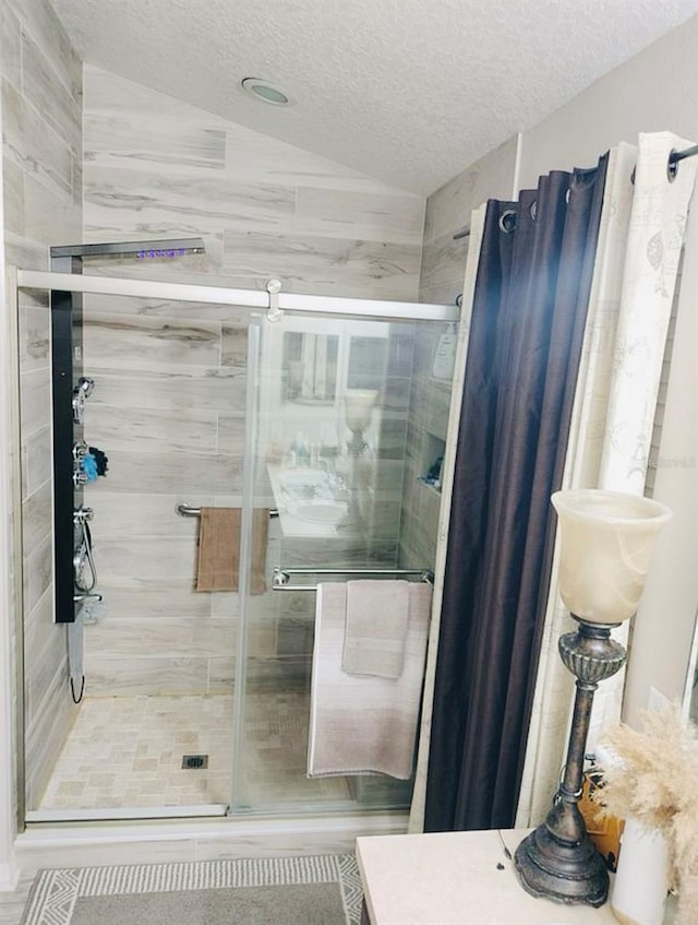 725 Ashworth Overlook Dr Unit C, Apopka, FL 32712 - full bath featuring a textured ceiling, a shower stall, and vaulted ceiling