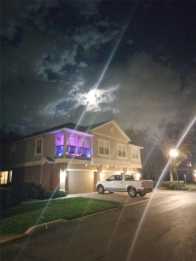 725 Ashworth Overlook Dr Unit C, Apopka, FL 32712 - view of front of home featuring an attached garage, concrete driveway, stucco siding, and a balcony
