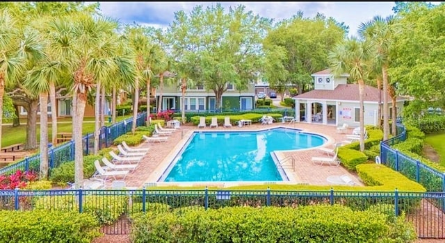 725 Ashworth Overlook Dr Unit C, Apopka, FL 32712 - community pool featuring a patio and view of scattered trees