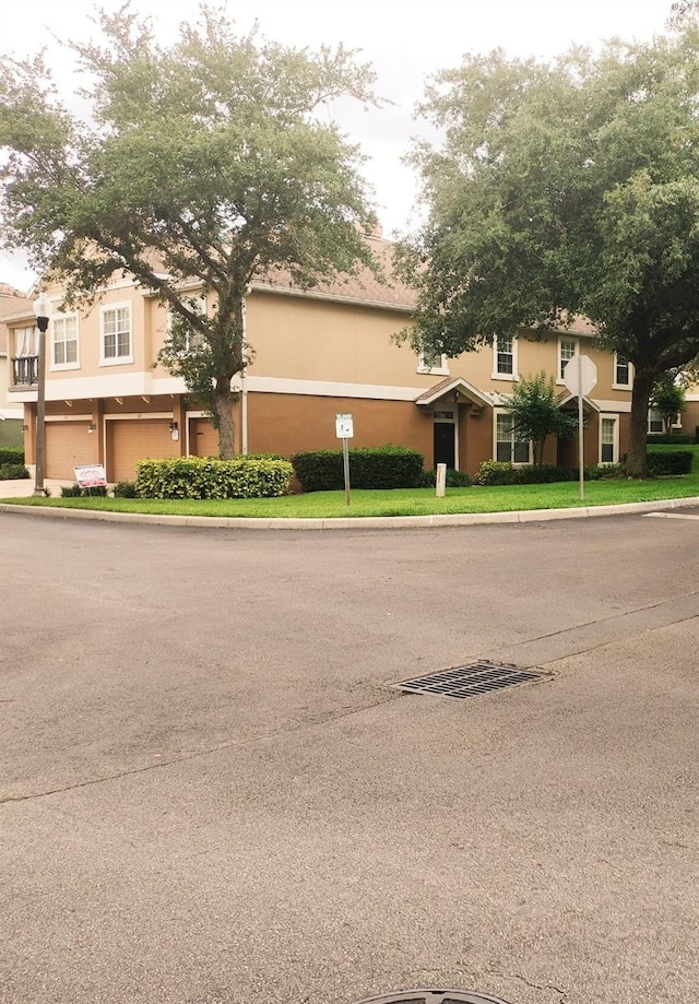 725 Ashworth Overlook Dr Unit C, Apopka, FL 32712 - view of front facade with stucco siding and an attached garage