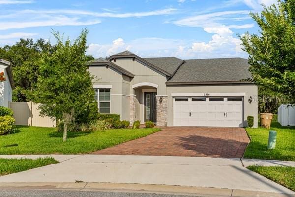 2914 Scarlett Dr, Saint Cloud, FL 34772 - view of front of house featuring decorative driveway and an attached garage