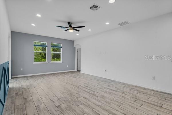 2914 Scarlett Dr, Saint Cloud, FL 34772 - unfurnished living room with light wood finished floors, ceiling fan, recessed lighting, and baseboards