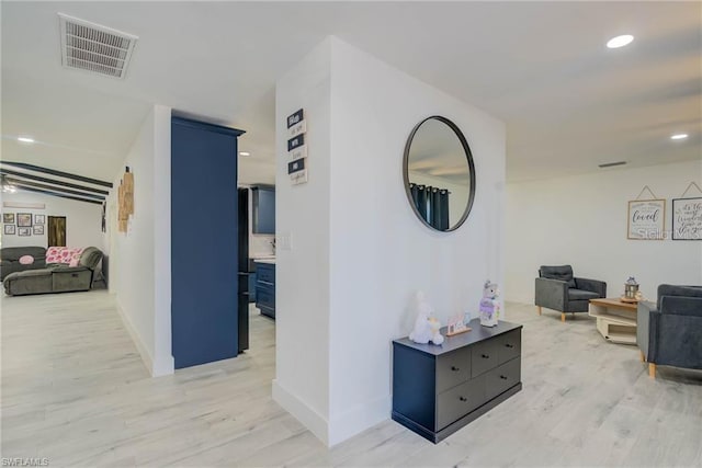 hall featuring light wood-style flooring, baseboards, and recessed lighting