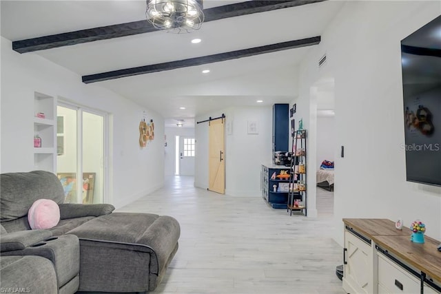 living area with a barn door, light wood-type flooring, recessed lighting, and baseboards