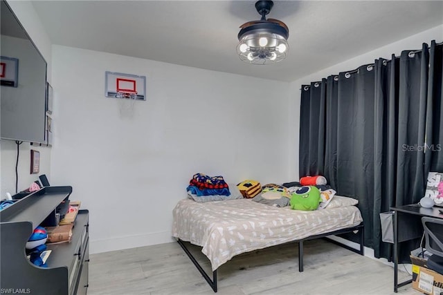 bedroom with light wood-style flooring and baseboards