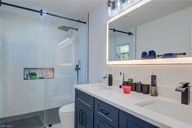 full bath featuring a marble finish shower, toilet, and double vanity