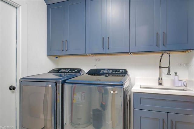 laundry area with independent washer and dryer and cabinet space