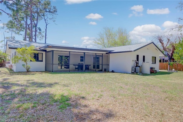 rear view of property featuring stucco siding