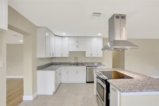 2835 Bongart Rd, Winter Park, FL 32792 - kitchen featuring island range hood, appliances with stainless steel finishes, a sink, light stone countertops, and recessed lighting