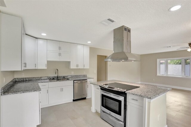 2835 Bongart Rd, Winter Park, FL 32792 - kitchen with appliances with stainless steel finishes, island exhaust hood, a sink, white cabinetry, and recessed lighting