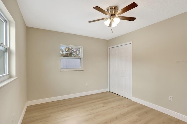 2835 Bongart Rd, Winter Park, FL 32792 - unfurnished bedroom with light wood-style flooring, a closet, baseboards, and a ceiling fan