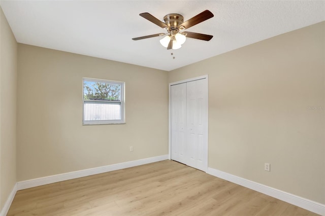 2835 Bongart Rd, Winter Park, FL 32792 - unfurnished bedroom featuring light wood-style flooring, baseboards, a closet, and a ceiling fan