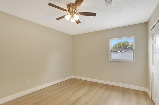 2835 Bongart Rd, Winter Park, FL 32792 - unfurnished bedroom with light wood-type flooring, baseboards, a closet, ceiling fan, and a textured ceiling