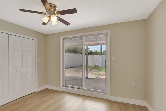 2835 Bongart Rd, Winter Park, FL 32792 - unfurnished bedroom featuring access to outside, light wood finished floors, baseboards, and a ceiling fan