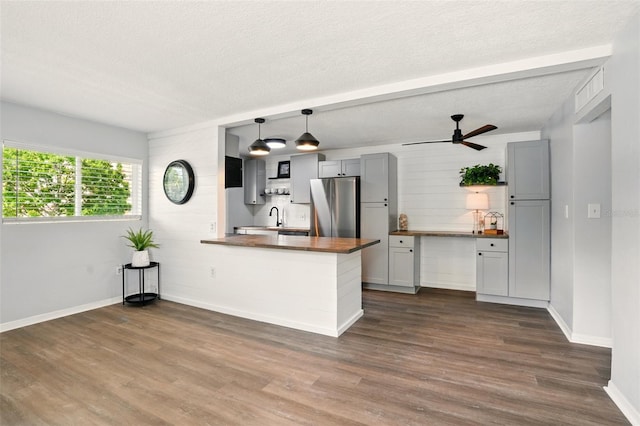 320 Lakeview St Unit 220, Orlando, FL 32804 - kitchen with freestanding refrigerator, a peninsula, dark wood-type flooring, a sink, and baseboards
