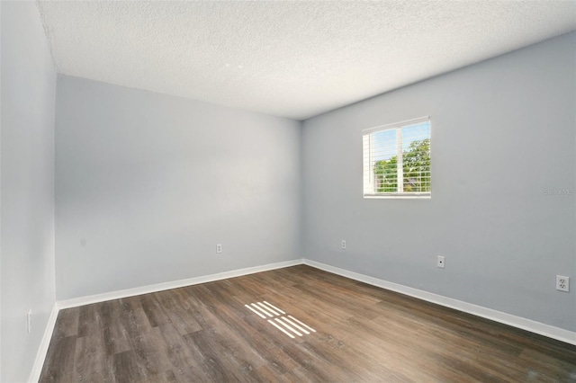 320 Lakeview St Unit 220, Orlando, FL 32804 - spare room featuring dark wood-style flooring, baseboards, and a textured ceiling