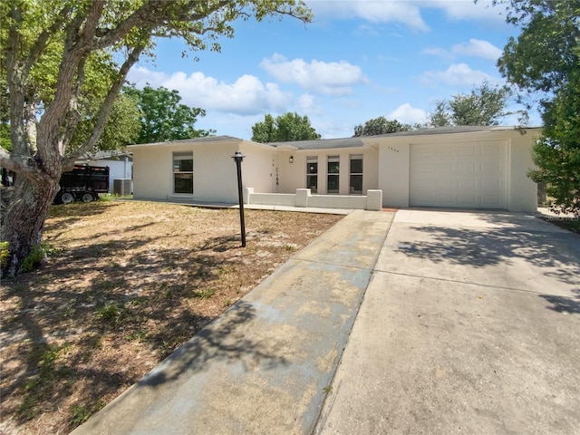 7604 Tyson Dr, Port Richey, FL 34668 - ranch-style home with stucco siding, an attached garage, concrete driveway, and cooling unit