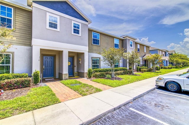 322 Annabelle Way, Davenport, FL 33837 - view of property featuring uncovered parking, a residential view, and stucco siding