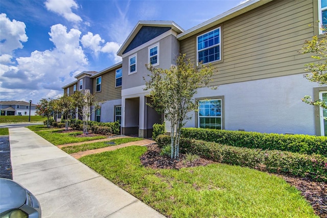 322 Annabelle Way, Davenport, FL 33837 - view of front of house with stucco siding, a residential view, and a front yard