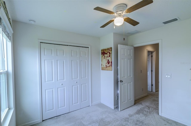 322 Annabelle Way, Davenport, FL 33837 - unfurnished bedroom featuring light carpet, a closet, and a ceiling fan