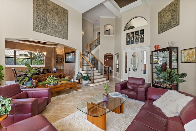 1010 Juliette Blvd, Mount Dora, FL 32757 - tiled living area featuring a towering ceiling, arched walkways, a chandelier, stairs, and baseboards