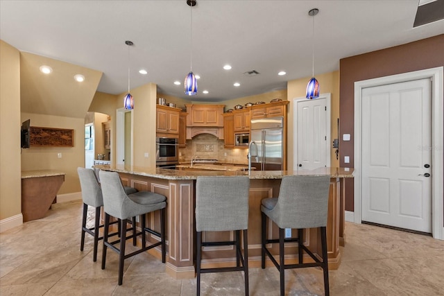 1010 Juliette Blvd, Mount Dora, FL 32757 - kitchen featuring built in appliances, recessed lighting, decorative backsplash, arched walkways, and a spacious island