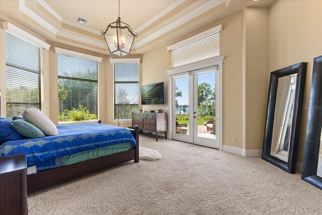 1010 Juliette Blvd, Mount Dora, FL 32757 - bedroom with crown molding, access to exterior, a chandelier, carpet flooring, and a raised ceiling