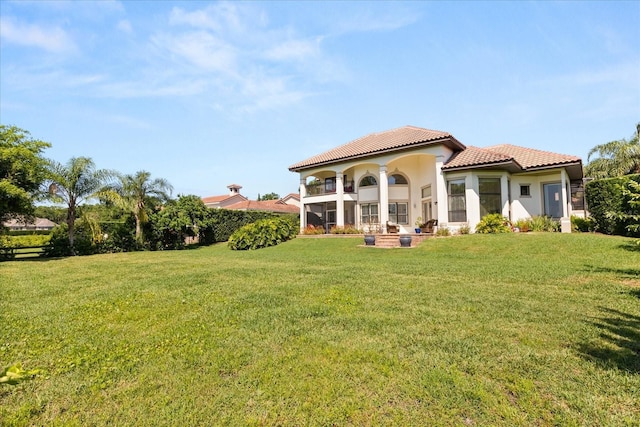 1010 Juliette Blvd, Mount Dora, FL 32757 - back of house with a tiled roof, a yard, stucco siding, and a balcony