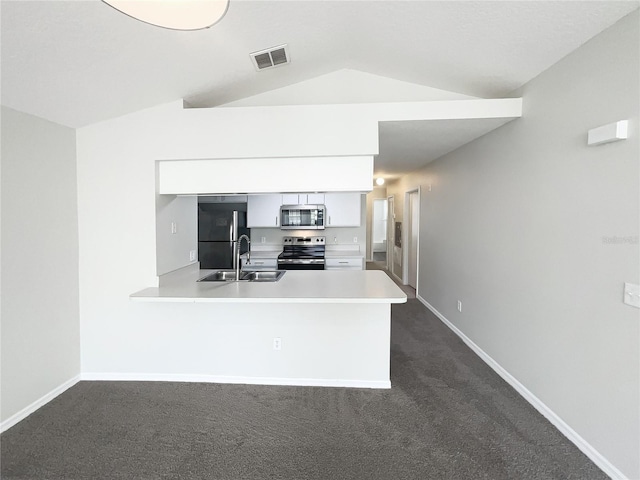 3142 Britannia Blvd Unit C, Kissimmee, FL 34747 - kitchen with stainless steel appliances, a sink, lofted ceiling, white cabinetry, and light countertops