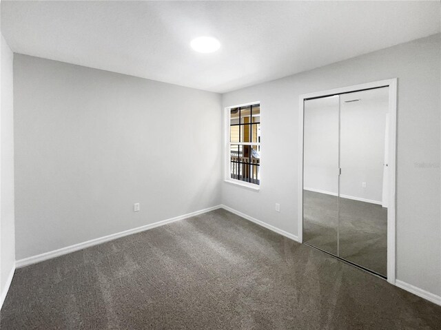 3142 Britannia Blvd Unit C, Kissimmee, FL 34747 - unfurnished bedroom featuring carpet, a closet, and baseboards