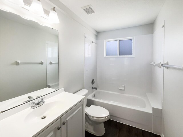 3142 Britannia Blvd Unit C, Kissimmee, FL 34747 - bathroom featuring toilet, vanity, wood finished floors, and shower / bathtub combination