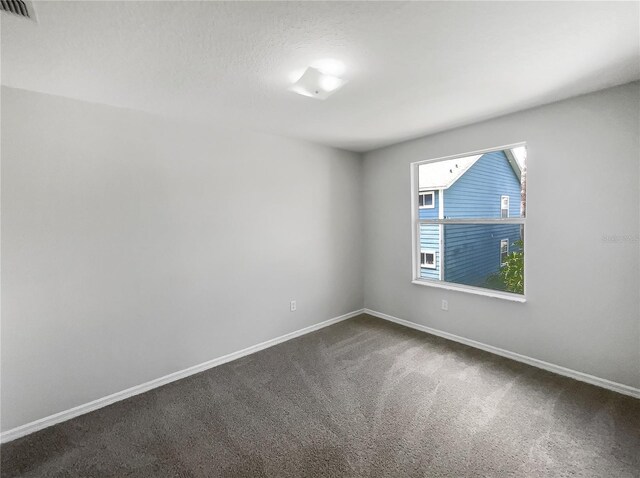 3142 Britannia Blvd Unit C, Kissimmee, FL 34747 - empty room featuring dark colored carpet and baseboards