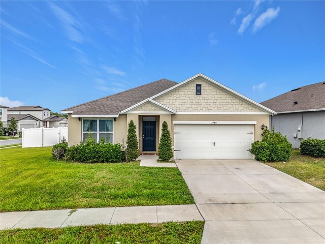 3980 Gadwall Pl, Leesburg, FL 34748 - view of front of home featuring stucco siding, an attached garage, and concrete driveway