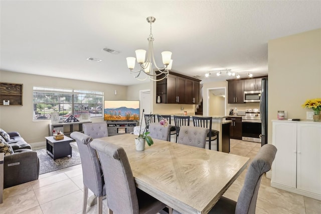 8652 Savory Dr, Orlando, FL 32825 - dining space with a chandelier and light tile patterned flooring