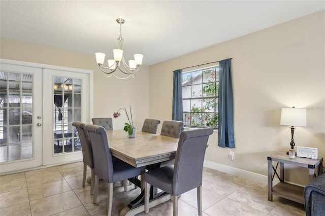 8652 Savory Dr, Orlando, FL 32825 - dining space with a chandelier, light tile patterned flooring, french doors, and baseboards