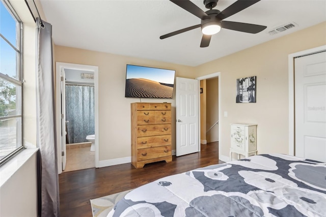 8652 Savory Dr, Orlando, FL 32825 - bedroom featuring wood finished floors, baseboards, ensuite bath, and ceiling fan