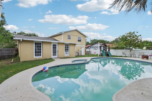 8652 Savory Dr, Orlando, FL 32825 - view of pool with a playground, a fenced backyard, a pool with connected hot tub, and a patio area