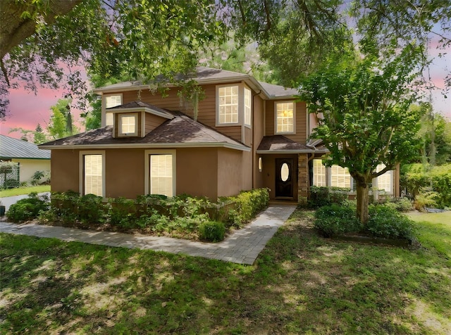 556 Lake Ave, Altamonte Springs, FL 32701 - view of front of property featuring stucco siding, a lawn, and a shingled roof