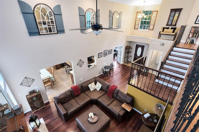 556 Lake Ave, Altamonte Springs, FL 32701 - living room with wood finished floors, a chandelier, stairway, a ceiling fan, and a high ceiling