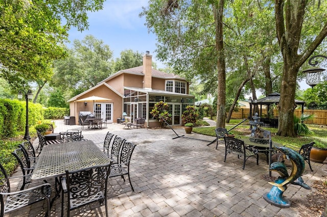 556 Lake Ave, Altamonte Springs, FL 32701 - fenced backyard featuring french doors, a gazebo, outdoor dining area, and a patio