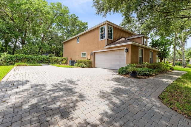 556 Lake Ave, Altamonte Springs, FL 32701 - view of side of property with stucco siding and decorative driveway