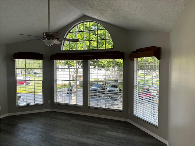 652 Roaring Dr Unit 234, Altamonte Springs, FL 32714 - unfurnished dining area with lofted ceiling, a ceiling fan, a textured ceiling, healthy amount of natural light, and dark wood-type flooring