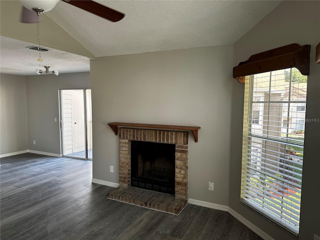 652 Roaring Dr Unit 234, Altamonte Springs, FL 32714 - unfurnished living room with a textured ceiling, dark wood-style floors, ceiling fan, a brick fireplace, and baseboards