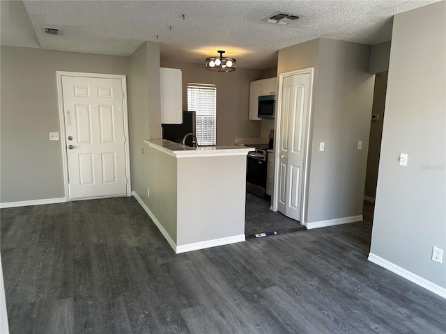 652 Roaring Dr Unit 234, Altamonte Springs, FL 32714 - kitchen with appliances with stainless steel finishes, dark wood-style flooring, white cabinetry, baseboards, and light countertops