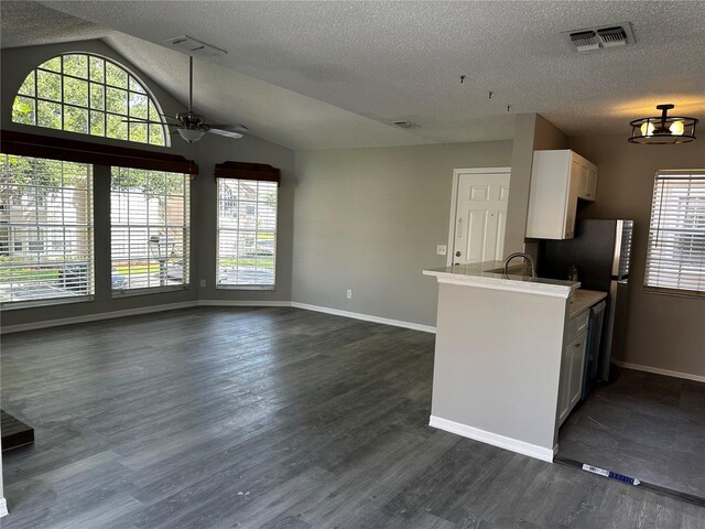 652 Roaring Dr Unit 234, Altamonte Springs, FL 32714 - kitchen featuring ceiling fan, a textured ceiling, lofted ceiling, baseboards, and white cabinetry
